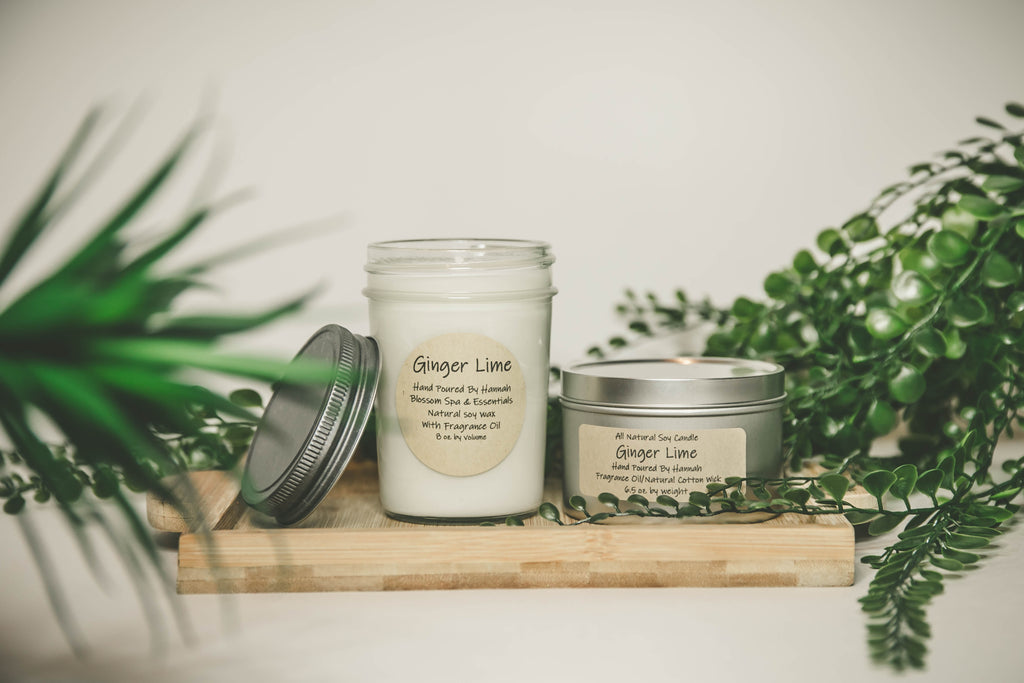 ginger lime homemade soy candle jar and tin with wood and greenery in background